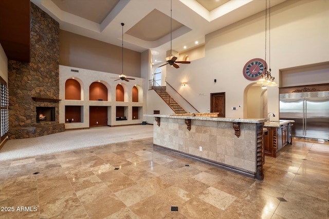 3523 E Presidio Cir, Mesa, AZ 85213 - kitchen with a towering ceiling, a ceiling fan, arched walkways, a sink, and built in fridge