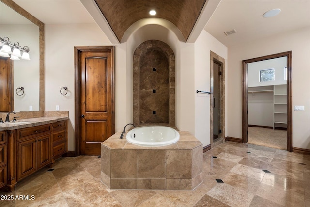 3523 E Presidio Cir, Mesa, AZ 85213 - full bath featuring a garden tub, vanity, baseboards, a stall shower, and a walk in closet