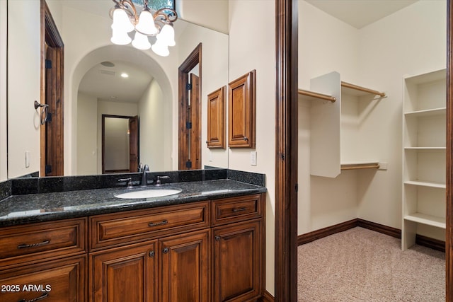3523 E Presidio Cir, Mesa, AZ 85213 - bathroom featuring vanity, baseboards, a chandelier, and a spacious closet