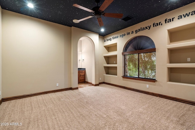 3523 E Presidio Cir, Mesa, AZ 85213 - carpeted empty room with arched walkways, built in features, a ceiling fan, baseboards, and recessed lighting