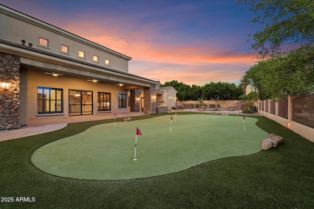 3523 E Presidio Cir, Mesa, AZ 85213 - fenced backyard featuring a putting green and ceiling fan