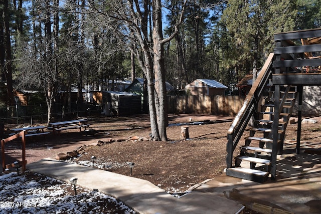 view of yard featuring stairway and fence