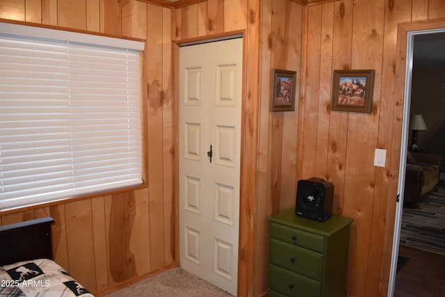 bedroom featuring wood walls