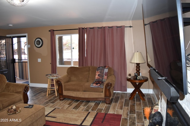 living room with baseboards and wood tiled floor