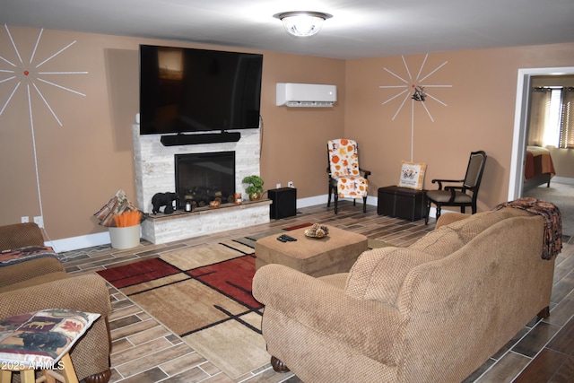 living room featuring baseboards, a fireplace, wood tiled floor, and a wall unit AC