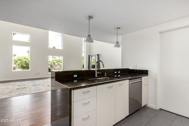 1111 W University Dr Unit 3016, Tempe, AZ 85281 - kitchen featuring dishwasher, a sink, a peninsula, pendant lighting, and white cabinetry