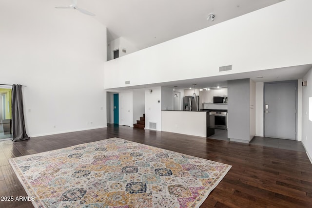 1111 W University Dr Unit 3016, Tempe, AZ 85281 - living room featuring a high ceiling, stairs, dark wood finished floors, baseboards, and ceiling fan