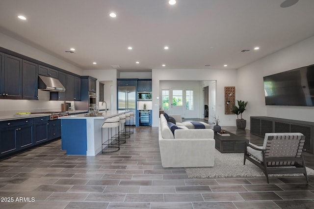 11534 N Jerome St, Surprise, AZ 85388 - living room with beverage cooler, recessed lighting, and light wood-style floors