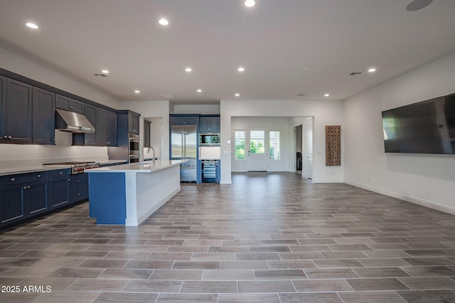 11534 N Jerome St, Surprise, AZ 85388 - kitchen with built in appliances, open floor plan, under cabinet range hood, recessed lighting, and wine cooler
