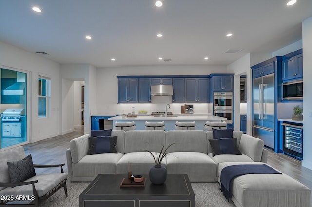 11534 N Jerome St, Surprise, AZ 85388 - living area featuring wine cooler, recessed lighting, light wood-style floors, and baseboards
