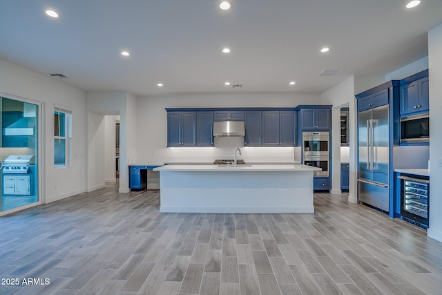 11534 N Jerome St, Surprise, AZ 85388 - kitchen featuring under cabinet range hood, built in appliances, wine cooler, light countertops, and recessed lighting