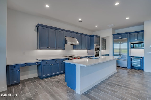 11534 N Jerome St, Surprise, AZ 85388 - kitchen with built in appliances, under cabinet range hood, wine cooler, light countertops, and recessed lighting
