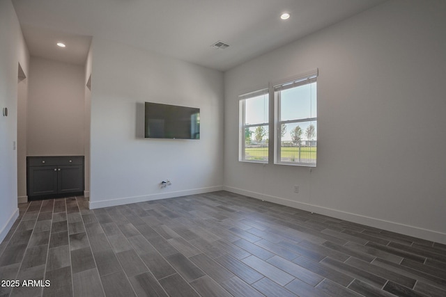 11534 N Jerome St, Surprise, AZ 85388 - unfurnished living room featuring dark wood-style flooring, baseboards, and recessed lighting