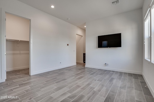11534 N Jerome St, Surprise, AZ 85388 - unfurnished living room featuring light wood-style floors, baseboards, and recessed lighting