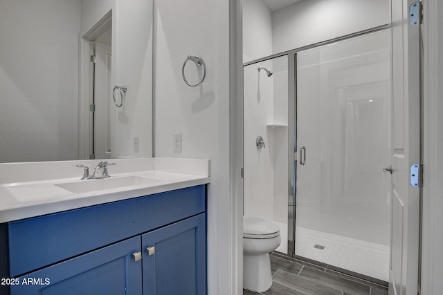 11534 N Jerome St, Surprise, AZ 85388 - bathroom featuring a stall shower, toilet, vanity, and wood finish floors