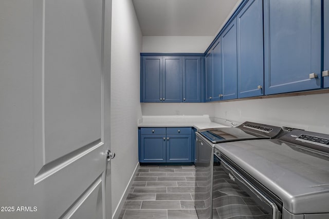 11534 N Jerome St, Surprise, AZ 85388 - washroom featuring cabinet space, washer and dryer, baseboards, and wood finish floors