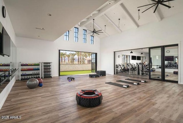 11534 N Jerome St, Surprise, AZ 85388 - exercise room featuring wood finished floors, high vaulted ceiling, beamed ceiling, and a ceiling fan