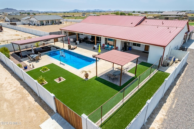 view of swimming pool featuring an outdoor hangout area, a yard, a mountain view, and a patio