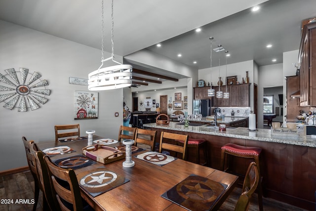 dining area with a notable chandelier and dark hardwood / wood-style flooring