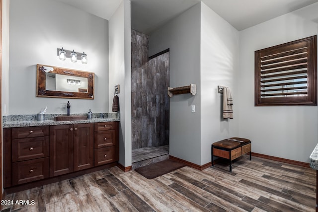 bathroom featuring vanity, walk in shower, and hardwood / wood-style floors