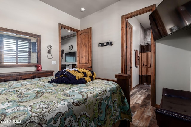 bedroom with dark hardwood / wood-style flooring