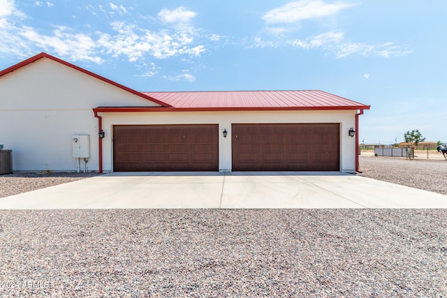 view of front of property with central air condition unit and a garage