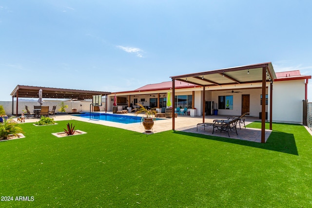 back of property with a patio, a lawn, and ceiling fan