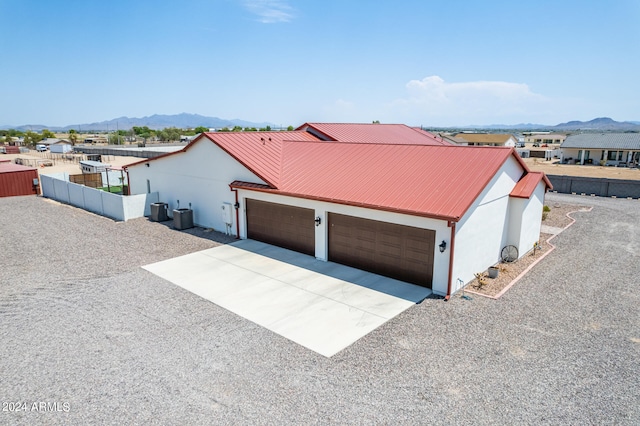 single story home featuring a garage and a mountain view