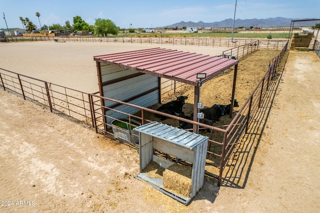 view of stable with a rural view and a mountain view