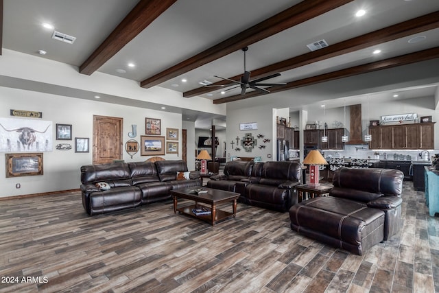 living room featuring beamed ceiling, sink, dark hardwood / wood-style floors, and ceiling fan