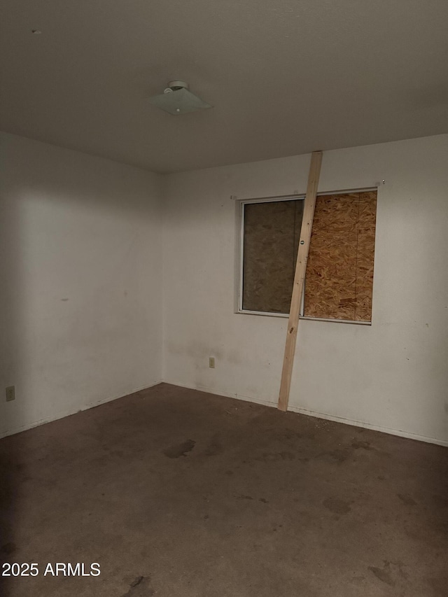unfurnished room with dark colored carpet