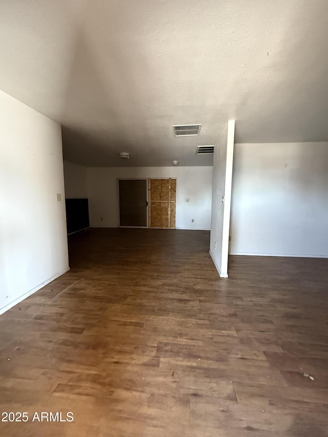 interior space with visible vents and wood finished floors