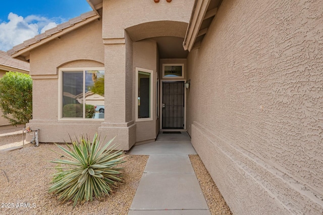 property entrance featuring stucco siding