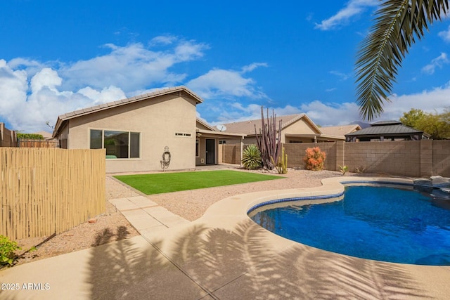 view of swimming pool featuring a patio area, a fenced backyard, a fenced in pool, and a yard