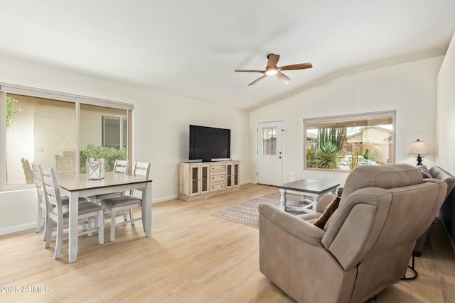 living room with lofted ceiling, baseboards, ceiling fan, and light wood finished floors