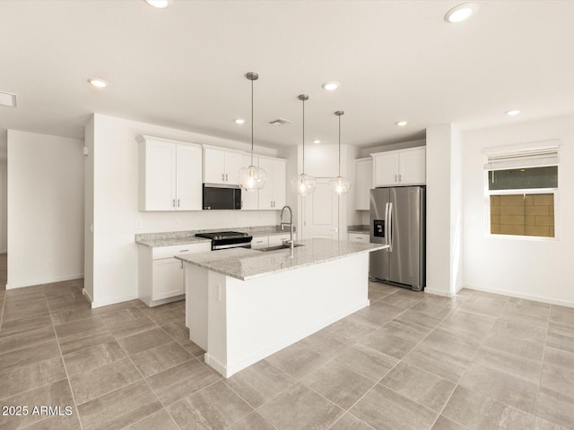 kitchen featuring stainless steel appliances, white cabinetry, a center island with sink, and a sink