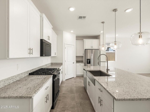 kitchen with a kitchen island with sink, a sink, white cabinetry, appliances with stainless steel finishes, and pendant lighting