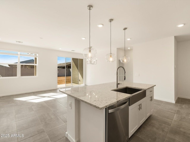 kitchen featuring a sink, white cabinetry, hanging light fixtures, stainless steel dishwasher, and an island with sink