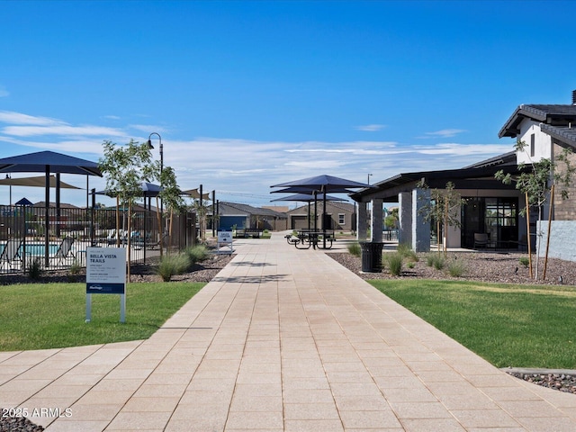 view of property's community featuring fence and a yard