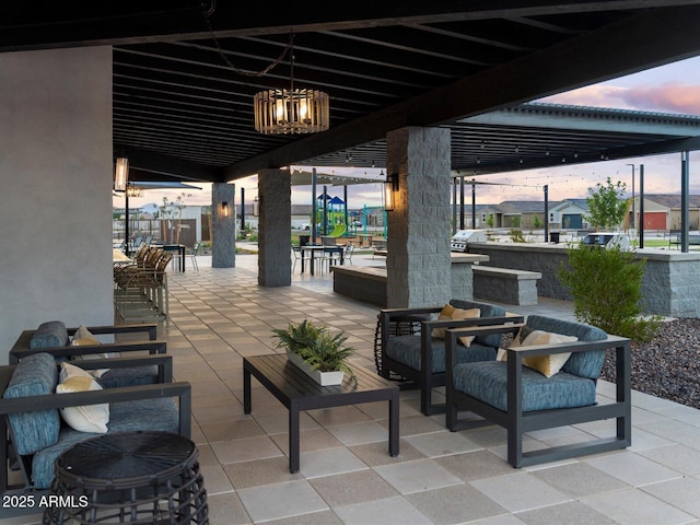 patio terrace at dusk featuring an outdoor hangout area