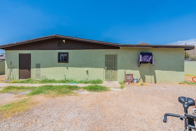 rear view of property with stucco siding