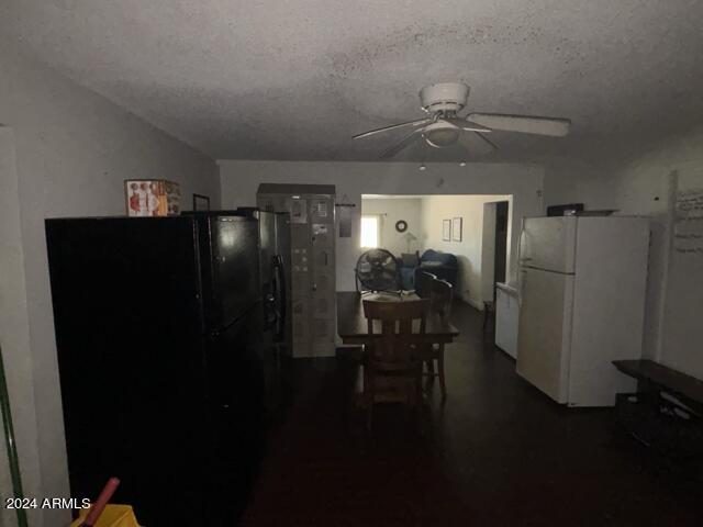 dining area featuring a ceiling fan and a textured ceiling