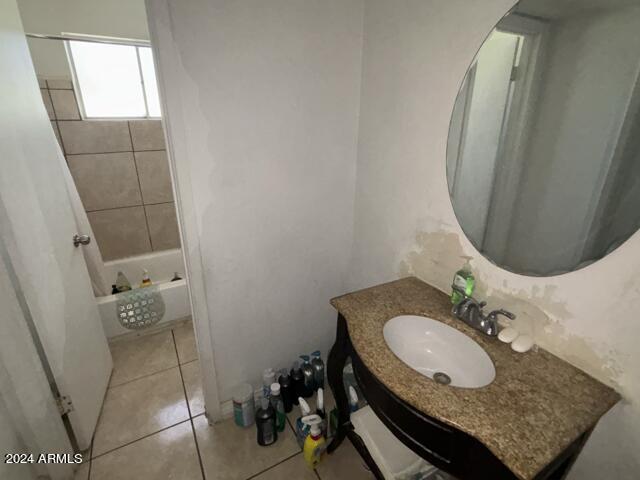 bathroom with tile patterned flooring, shower / tub combo with curtain, and vanity