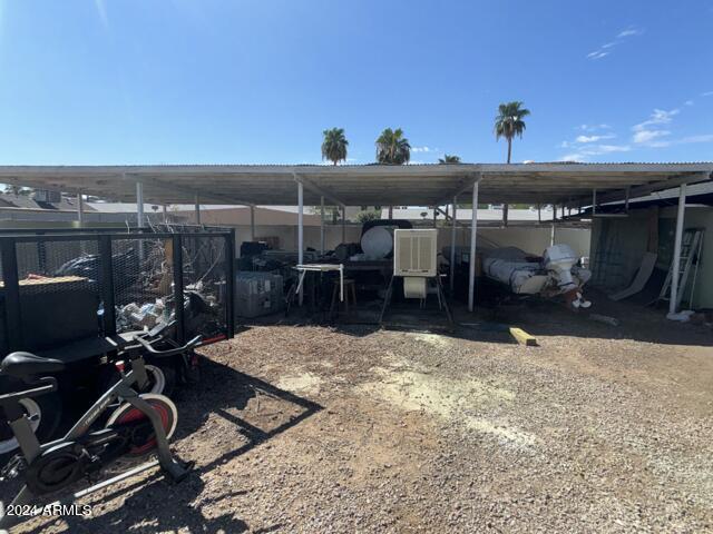 view of parking / parking lot with a carport and driveway