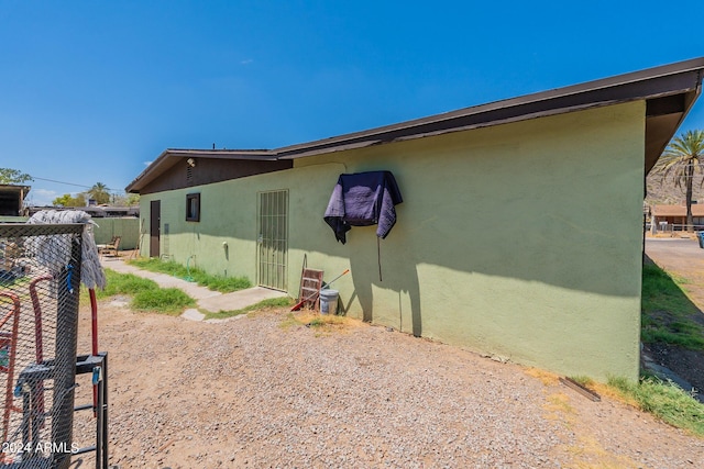 view of home's exterior featuring fence and stucco siding