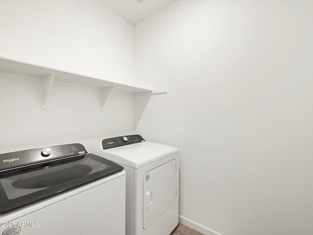 laundry area with laundry area, independent washer and dryer, and baseboards