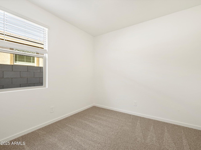 carpeted spare room with baseboards