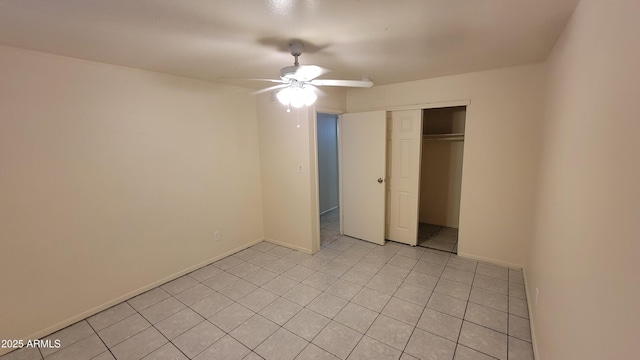 unfurnished bedroom featuring ceiling fan, a closet, and light tile patterned floors