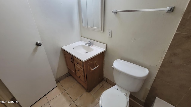 bathroom featuring vanity, tile patterned floors, and toilet