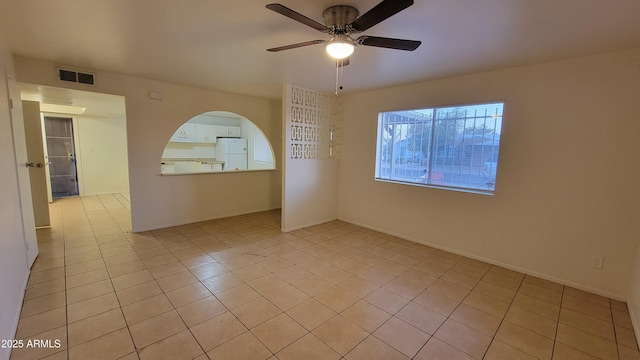 tiled empty room with ceiling fan